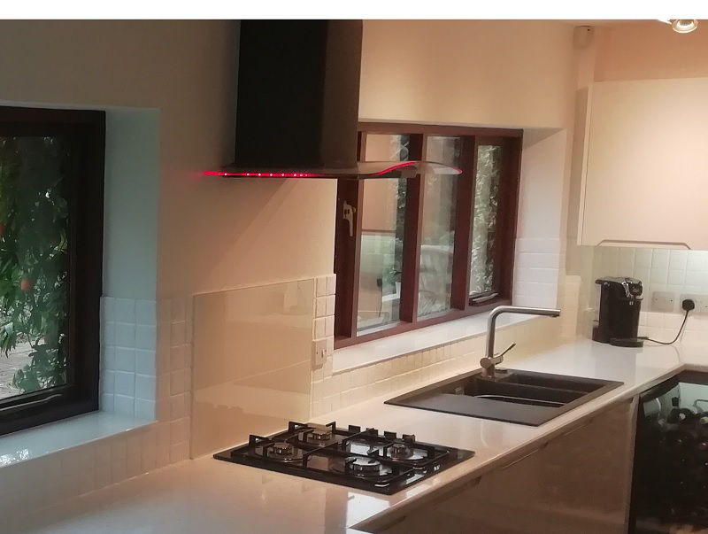 Can a glass splashback be fitted on top of tiles